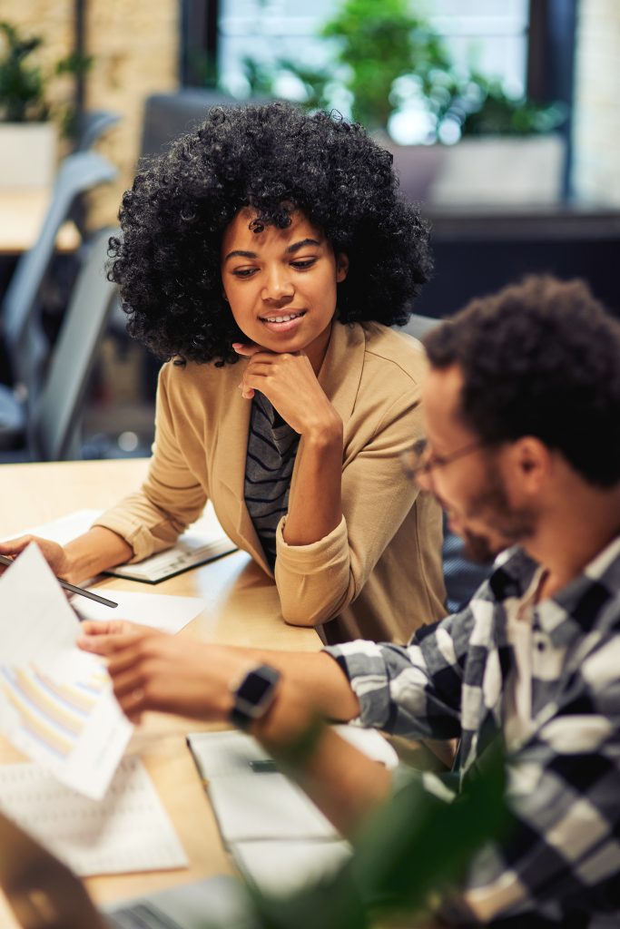 two young diverse coworkers analyzing sales report 2023 11 27 05 01 42 utc